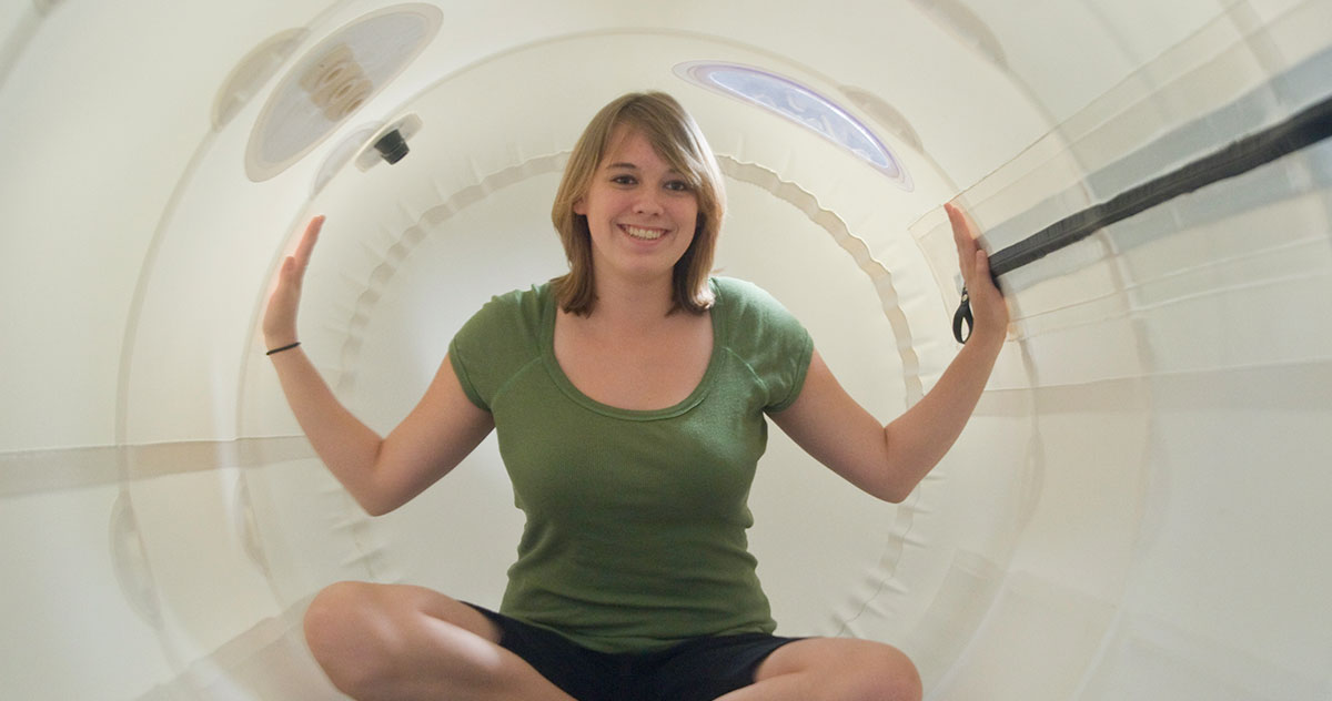 Woman with hands up in hyperbaric chamber
